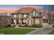 Elegant brick and stone home featuring a welcoming front porch and professionally landscaped front yard at 3149 Hidden Falls Ne Dr, Buford, GA 30519