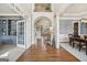 Bright foyer with gleaming hardwood floors, an open staircase, and views into the dining and living spaces at 3149 Hidden Falls Ne Dr, Buford, GA 30519