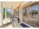 Charming front porch with a double-door entrance, classic rocking chairs, and stone detailing at 3149 Hidden Falls Ne Dr, Buford, GA 30519