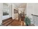 Beautifully designed hallway featuring hardwood floors, decorative rug, and decorative iron stair railing at 3149 Hidden Falls Ne Dr, Buford, GA 30519