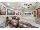 Spacious living room features a leather sofa, media center, and movie poster decorations at 3149 Hidden Falls Ne Dr, Buford, GA 30519
