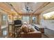Charming living room with exposed brick, wood ceiling beams and a leather sofa at 3149 Hidden Falls Ne Dr, Buford, GA 30519