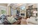 Cozy living room features a stone fireplace, built-in shelves, and view to the outdoor pool at 3149 Hidden Falls Ne Dr, Buford, GA 30519
