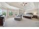 Expansive main bedroom features tray ceilings, large windows, and a cozy sitting area at 3149 Hidden Falls Ne Dr, Buford, GA 30519