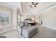 Spacious main bedroom with tray ceiling, neutral decor, and a comfortable sitting area at 3149 Hidden Falls Ne Dr, Buford, GA 30519
