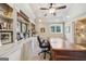 Office featuring built-in shelves, a ceiling fan, and a large writing desk at 3149 Hidden Falls Ne Dr, Buford, GA 30519
