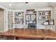 Executive office space featuring custom built-in shelving, hardwood desk, and natural lighting at 3149 Hidden Falls Ne Dr, Buford, GA 30519