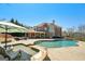 Stunning backyard pool and spa area with outdoor seating and beautiful brick home backdrop on a sunny day at 3149 Hidden Falls Ne Dr, Buford, GA 30519
