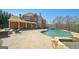 Beautiful pool and patio area with brick house backdrop, providing a luxurious outdoor living space at 3149 Hidden Falls Ne Dr, Buford, GA 30519