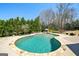 Expansive kidney-shaped pool surrounded by a patio and featuring a large tree line at 3149 Hidden Falls Ne Dr, Buford, GA 30519