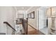 Staircase with wood flooring and wrought iron railing at 3149 Hidden Falls Ne Dr, Buford, GA 30519