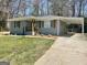 Well-maintained home with a covered carport, brick exterior, and a spacious front yard at 103 Greenwood Dr, Stockbridge, GA 30281