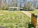 Single story home with a long driveway and carport surrounded by mature trees at 103 Greenwood Dr, Stockbridge, GA 30281