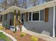 Inviting brick home with decorative shutters, updated landscaping, and a cozy front porch at 103 Greenwood Dr, Stockbridge, GA 30281