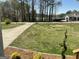 Residential home featuring a green lawn, driveway, and decorative bushes at 103 Greenwood Dr, Stockbridge, GA 30281