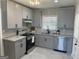 Updated kitchen featuring gray cabinets, stainless steel appliances, and a stylish subway tile backsplash at 103 Greenwood Dr, Stockbridge, GA 30281