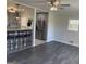 Open-concept living area featuring modern lighting, wood floors, and a view to the kitchen at 103 Greenwood Dr, Stockbridge, GA 30281