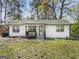 Charming single-story home with a well-maintained yard, inviting entrance and black trimmed windows at 117 Spring St, Stockbridge, GA 30281