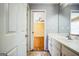 Bathroom featuring a white single sink vanity and a view into the bedroom at 132 Westmont Way, Tyrone, GA 30290