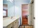 Well-lit bathroom with an expansive vanity and a bedroom just beyond the doorway, offering convenient access at 132 Westmont Way, Tyrone, GA 30290