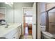 Bathroom with a white sink vanity and a view of the bedroom and walk-in shower at 132 Westmont Way, Tyrone, GA 30290