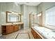 Bathroom features a walk-in shower, soaking tub and vanity with a large mirror at 132 Westmont Way, Tyrone, GA 30290
