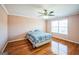 Bright bedroom featuring hardwood floors, large windows, and a ceiling fan at 132 Westmont Way, Tyrone, GA 30290