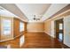 Spacious bedroom with tray ceilings, fan, and gleaming hardwood floors at 132 Westmont Way, Tyrone, GA 30290