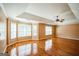 Spacious, empty bedroom bathed in natural light with smooth hardwood flooring and a ceiling fan for added comfort at 132 Westmont Way, Tyrone, GA 30290