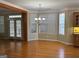 Cozy dining area with ample windows and hardwood floors, open to the kitchen at 132 Westmont Way, Tyrone, GA 30290