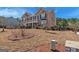 Two-story brick home boasts a manicured lawn, mature trees, and a welcoming front porch at 132 Westmont Way, Tyrone, GA 30290