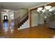 Inviting foyer with beautiful hardwood floors, elegant staircase, and a grand chandelier, creating a welcoming entrance at 132 Westmont Way, Tyrone, GA 30290