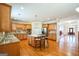 Spacious kitchen featuring stainless appliances, central island with seating, and hardwood floors at 132 Westmont Way, Tyrone, GA 30290