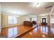 Spacious living room with hardwood floors, ample natural light, and elegant chandelier at 132 Westmont Way, Tyrone, GA 30290