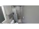 Compact bathroom features gray tile shower, modern fixtures, and updated toilet at 1901 E Farris Ave, East Point, GA 30344