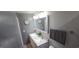 Bathroom featuring a double sink vanity, lighted mirror, and soothing gray walls at 1901 E Farris Ave, East Point, GA 30344