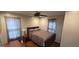 Cozy bedroom featuring a dark-framed bed, neutral walls, and soft natural light through sheer curtains at 1901 E Farris Ave, East Point, GA 30344