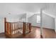Spacious attic with hardwood floors, natural light, and wooden railing at 2377 Beecher Sw Rd, Atlanta, GA 30311