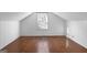 Bright, open attic space with hardwood floors and a large window at 2377 Beecher Sw Rd, Atlanta, GA 30311