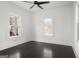 Bright bedroom with dark hardwood floors, three windows, and white trim at 2377 Beecher Sw Rd, Atlanta, GA 30311