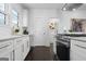 Bright kitchen featuring white cabinets, gold hardware, and stainless steel appliances at 2377 Beecher Sw Rd, Atlanta, GA 30311