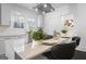 Bright kitchen with quartz countertops, center island, modern pendants, and seating at 2377 Beecher Sw Rd, Atlanta, GA 30311
