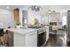 Open-concept kitchen with an island stove and living area with modern fireplace at 2377 Beecher Sw Rd, Atlanta, GA 30311