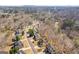 Aerial view of a suburban neighborhood with mature trees and a winding street at 3967 Bellingrath Main Nw, Kennesaw, GA 30144