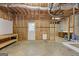 Unfinished basement featuring a workbench, door, mini fridge, and insulation for future build-out at 3967 Bellingrath Main Nw, Kennesaw, GA 30144