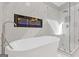 Luxurious bathroom featuring a standalone tub, marble walls, glass shower, and built-in fireplace at 3967 Bellingrath Main Nw, Kennesaw, GA 30144