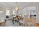 Bright dining room featuring a modern chandelier, a wooden table and chairs, and large windows at 3967 Bellingrath Main Nw, Kennesaw, GA 30144