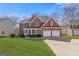 Beautiful two-story brick home boasts a well-manicured lawn and a three-car garage at 3967 Bellingrath Main Nw, Kennesaw, GA 30144