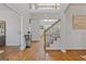 Elegant foyer featuring hardwood floors, a staircase, and a decorative table at 3967 Bellingrath Main Nw, Kennesaw, GA 30144