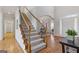 Open foyer with a staircase leading to the second floor, hardwood flooring, and natural light at 3967 Bellingrath Main Nw, Kennesaw, GA 30144